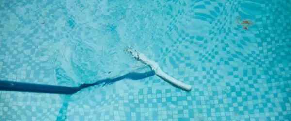 Brushing pool walls